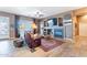 This spacious living room boasts a fireplace, wood-look tile, overhead lighting, and natural light at 3948 E Vallejo Dr, Gilbert, AZ 85298
