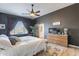 Comfortable main bedroom with dark walls, light wood floors, and soft bedding for a peaceful ambiance at 3948 E Vallejo Dr, Gilbert, AZ 85298