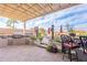 Inviting outdoor kitchen with built in grill, bar seating, and shaded pergola, perfect for entertaining at 3948 E Vallejo Dr, Gilbert, AZ 85298