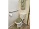 Bathroom featuring a toilet, grab bar, and a matching rug and toilet cover at 4065 E University Dr # 83, Mesa, AZ 85205