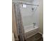 Bathroom showing a bathtub and shower combination with a gray patterned curtain at 4065 E University Dr # 83, Mesa, AZ 85205