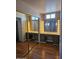 Bedroom showing a vanity with lit mirrors and hard wood floors at 4065 E University Dr # 83, Mesa, AZ 85205