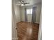 Bedroom displaying hard wood floors, a ceiling fan, curtains, and a window at 4065 E University Dr # 83, Mesa, AZ 85205