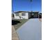 Single story home with a driveway, carport and desert landscaping at 4065 E University Dr # 83, Mesa, AZ 85205