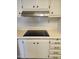 Kitchen cooktop with stainless hood and white cabinets at 4065 E University Dr # 83, Mesa, AZ 85205