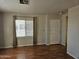 Bright living room with wood floors, large windows, and neutral wall color at 4065 E University Dr # 83, Mesa, AZ 85205
