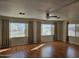 Bright living room featuring hardwood floors, ceiling fan and large windows at 4065 E University Dr # 83, Mesa, AZ 85205