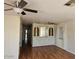 Living room featuring wood floors, cabinet storage, and a ceiling fan at 4065 E University Dr # 83, Mesa, AZ 85205