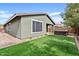 Spacious backyard featuring artificial turf, desert landscaping, and comfortable wicker patio furniture for easy outdoor living at 4197 E Rawhide St, Gilbert, AZ 85296