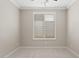 Neutral bedroom features plush carpet, a window with shutter blinds, and ample natural light at 4197 E Rawhide St, Gilbert, AZ 85296