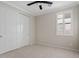 Cozy bedroom featuring a ceiling fan, window with shutters, and a closet at 4197 E Rawhide St, Gilbert, AZ 85296