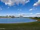 Scenic community view showcases a tranquil lake, lush green spaces, and clear blue skies at 4197 E Rawhide St, Gilbert, AZ 85296