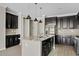 Kitchen featuring stainless appliances, dark wood cabinets, granite countertops, island, and pendant lighting at 4197 E Rawhide St, Gilbert, AZ 85296