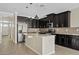 Open kitchen features stainless steel appliances, granite countertops, dark cabinets, and a center island at 4197 E Rawhide St, Gilbert, AZ 85296