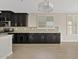 Kitchen featuring dark cabinets, tile floors, and windows with bright shutters at 4197 E Rawhide St, Gilbert, AZ 85296