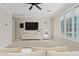 Bright living room featuring neutral tones, a large TV, and access to the outdoor patio at 4197 E Rawhide St, Gilbert, AZ 85296