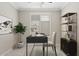 Cozy home office with a modern desk, decorative shelving, and plantation shutters at 4197 E Rawhide St, Gilbert, AZ 85296