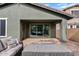 Inviting covered patio with comfortable wicker seating, perfect for relaxing or entertaining in the shade at 4197 E Rawhide St, Gilbert, AZ 85296