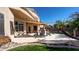 Inviting backyard patio with mature trees, a covered outdoor kitchen, pool and an outdoor seating area at 4235 W Harrison St, Chandler, AZ 85226