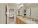 Bathroom featuring double sinks, a large mirror, and an open doorway to a sitting room at 4235 W Harrison St, Chandler, AZ 85226
