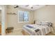A cozy bedroom with a queen bed, a window, carpeted floors, and neutral-toned walls at 4235 W Harrison St, Chandler, AZ 85226