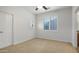 Neutral bedroom with a ceiling fan, carpeted floor, window with shutters, and bright natural light at 4235 W Harrison St, Chandler, AZ 85226