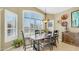 Formal dining room with dark wood table, modern chandelier and large windows at 4235 W Harrison St, Chandler, AZ 85226