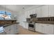 Well-equipped kitchen features stainless steel appliances, granite countertops, and ample storage for a practical cooking space at 4235 W Harrison St, Chandler, AZ 85226