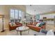 Bright living room with high ceilings and plantation shutters adjacent to kitchen and dining room at 4235 W Harrison St, Chandler, AZ 85226
