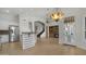 The open-concept kitchen and living area boasts modern appliances, arched doorways, and a cozy fireplace, seamlessly connecting spaces at 4235 W Harrison St, Chandler, AZ 85226