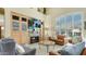 Bright living room features a fireplace, built-in cabinets, and large window with plantation shutters at 4235 W Harrison St, Chandler, AZ 85226