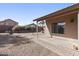 A clean backyard featuring a covered patio, gravel, and well-maintained landscaping in a suburban setting at 43815 W Cahill Dr, Maricopa, AZ 85138