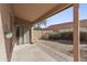 Covered patio overlooks the gravel backyard, enclosed by a block wall, ideal for outdoor enjoyment at 43815 W Cahill Dr, Maricopa, AZ 85138