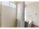 Bright bathroom featuring a bathtub with tile accents and a white shower curtain at 43815 W Cahill Dr, Maricopa, AZ 85138