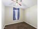 Empty bedroom featuring neutral walls, carpet floors, and a window with blinds at 43815 W Cahill Dr, Maricopa, AZ 85138