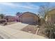 Single story home with desert landscaping and a two car garage at 43815 W Cahill Dr, Maricopa, AZ 85138