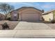 Inviting single-story home with a well-manicured desert landscape and neutral color palette at 43815 W Cahill Dr, Maricopa, AZ 85138