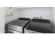 Modern laundry area with front-load washer and dryer, offering efficient laundry solutions at 43815 W Cahill Dr, Maricopa, AZ 85138