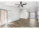 Bright, open living room featuring stylish flooring, neutral walls, and a contemporary ceiling fan at 43815 W Cahill Dr, Maricopa, AZ 85138