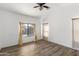 A spacious, bright main bedroom with stylish flooring, neutral walls, and a contemporary ceiling fan at 43815 W Cahill Dr, Maricopa, AZ 85138
