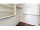 Walk-in closet with white walls, carpet flooring, built-in shelving, and clothes rods for ample storage at 43815 W Cahill Dr, Maricopa, AZ 85138