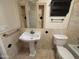 Charming bathroom with pedestal sink, decorative tile and updated fixtures at 4615 E Emerald Ave, Mesa, AZ 85206