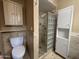 Clean primary bathroom with toilet, glass enclosed walk-in shower, and linen closet at 4615 E Emerald Ave, Mesa, AZ 85206