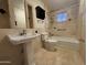 Bright bathroom featuring a tub with shower and marble-style tiling throughout at 4615 E Emerald Ave, Mesa, AZ 85206