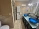 Primary bathroom featuring dual glass vessel sinks, walk-in shower, and linen closet at 4615 E Emerald Ave, Mesa, AZ 85206