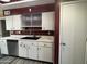 Functional kitchen with stainless steel dishwasher, sink, and white cabinets with laminate countertops at 4615 E Emerald Ave, Mesa, AZ 85206