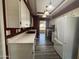 Well-lit kitchen with white cabinets, stainless steel appliances, hardwood floors, and modern lighting fixtures at 4615 E Emerald Ave, Mesa, AZ 85206