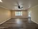 Well-lit living room featuring wood floors, ceiling fan, and a window and door with lots of natural light at 4615 E Emerald Ave, Mesa, AZ 85206