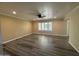 Bright living room with wood floors, ceiling fan, and large window with views of the outside at 4615 E Emerald Ave, Mesa, AZ 85206