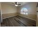 Bright and airy living room featuring new hardwood floors, ceiling fan, custom paint, and updated arched window at 4615 E Emerald Ave, Mesa, AZ 85206